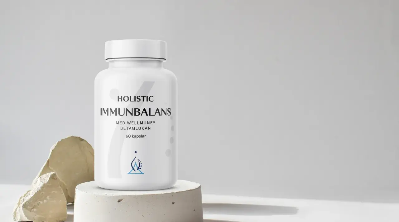 En vit burk med "Immunbalans" och "betaglukan" text. Minimalistisk design med stenar och betong.