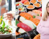 En kvinna med glasögon ler, bredvid en stor bricka med sushi och en sallad. Kanske en IBS-vänlig måltid?
