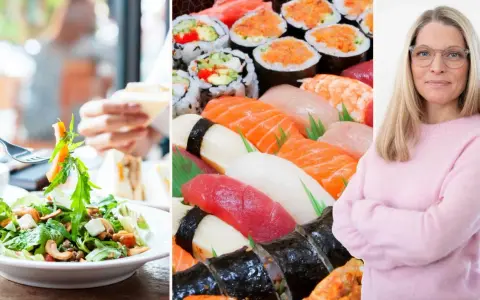 En kvinna med glasögon ler, bredvid en stor bricka med sushi och en sallad. Kanske en IBS-vänlig måltid?