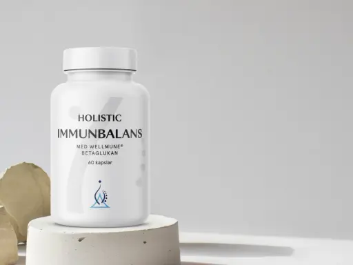 En vit burk med "Immunbalans" och "betaglukan" text. Minimalistisk design med stenar och betong.