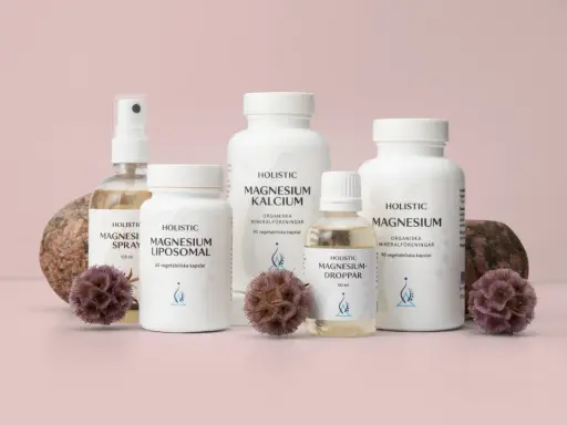 Holistic magnesiumprodukter: spray, liposomalkapslar, magnesium-kalciumkapslar, droppar och magnesiumcitratkapslar, dekorerade med stenar och torkade blommor.