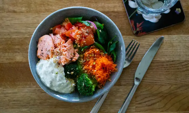 En härlig poke bowl med lax, broccoli, tomat och rivna morötter. Ett perfekt poke bowl recept för en hälsosam lunch.