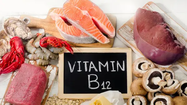 En tavla med texten "VITAMIN B12" omgiven av lax, lever, räkor, ostron, kött och champinjoner.